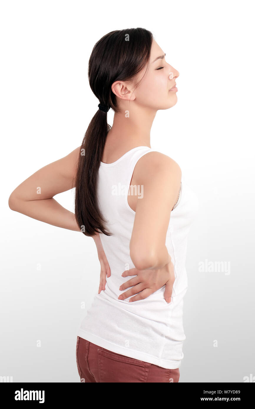 Young woman suffering from backache and flank pain on white background.  Cause of pain include UTI, kidney stones, gallbladder disease or muscle  problems. Health care and medical concept. Stock Photo
