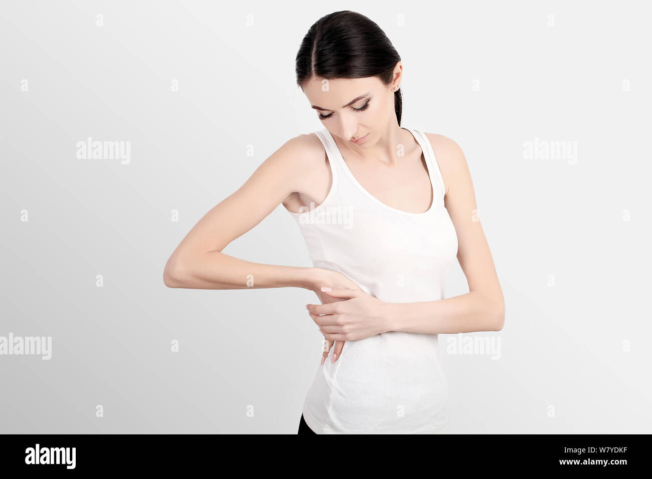 Woman Health Problem. Closeup Of Female With Fit Slim Body In Panties And  Bra Suffering From Pain And Holding Her Hands On The Loins. Renal Aches,  Backaches, Health Issues Concept Stock Photo