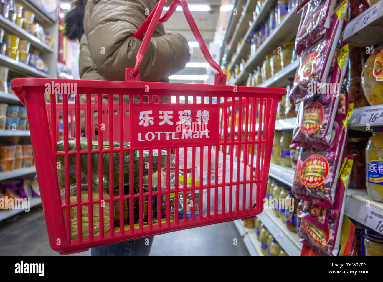 A customer shops at a Lotte Mart in Beijing, China, 2 March 2017.   South Korean products are witnessing an unprecedented boycott by the Chinese peopl Stock Photo