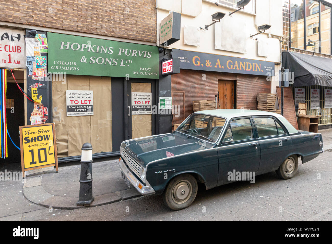 Street in Soho, London, set dressed for Last Night in Soho, an upcoming psychological horror film directed by Edgar Wright. Shop front and vintage car Stock Photo
