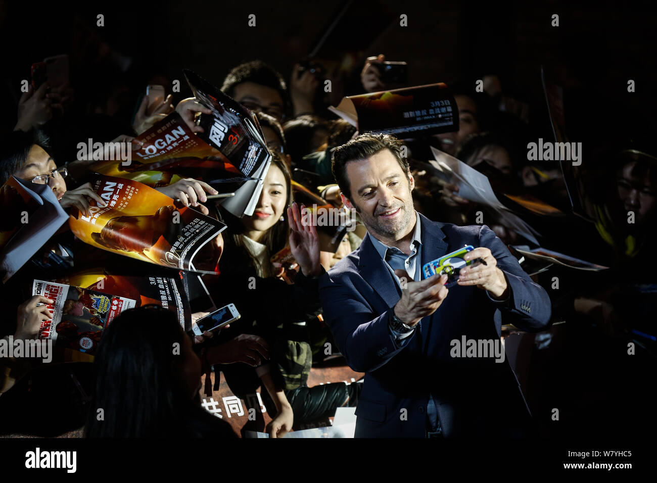 Australian actor Hugh Jackman takes a selfie with fans during a press conference to promote his first Asia movie premiere of 'Logan' in Beijing, China Stock Photo