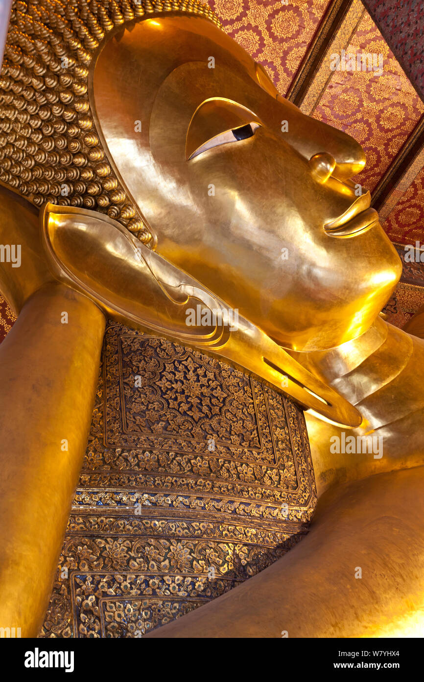 Golden statue of the reclining Buddha at Wat Pho in Bangkok. Thailand, September 2014. Stock Photo