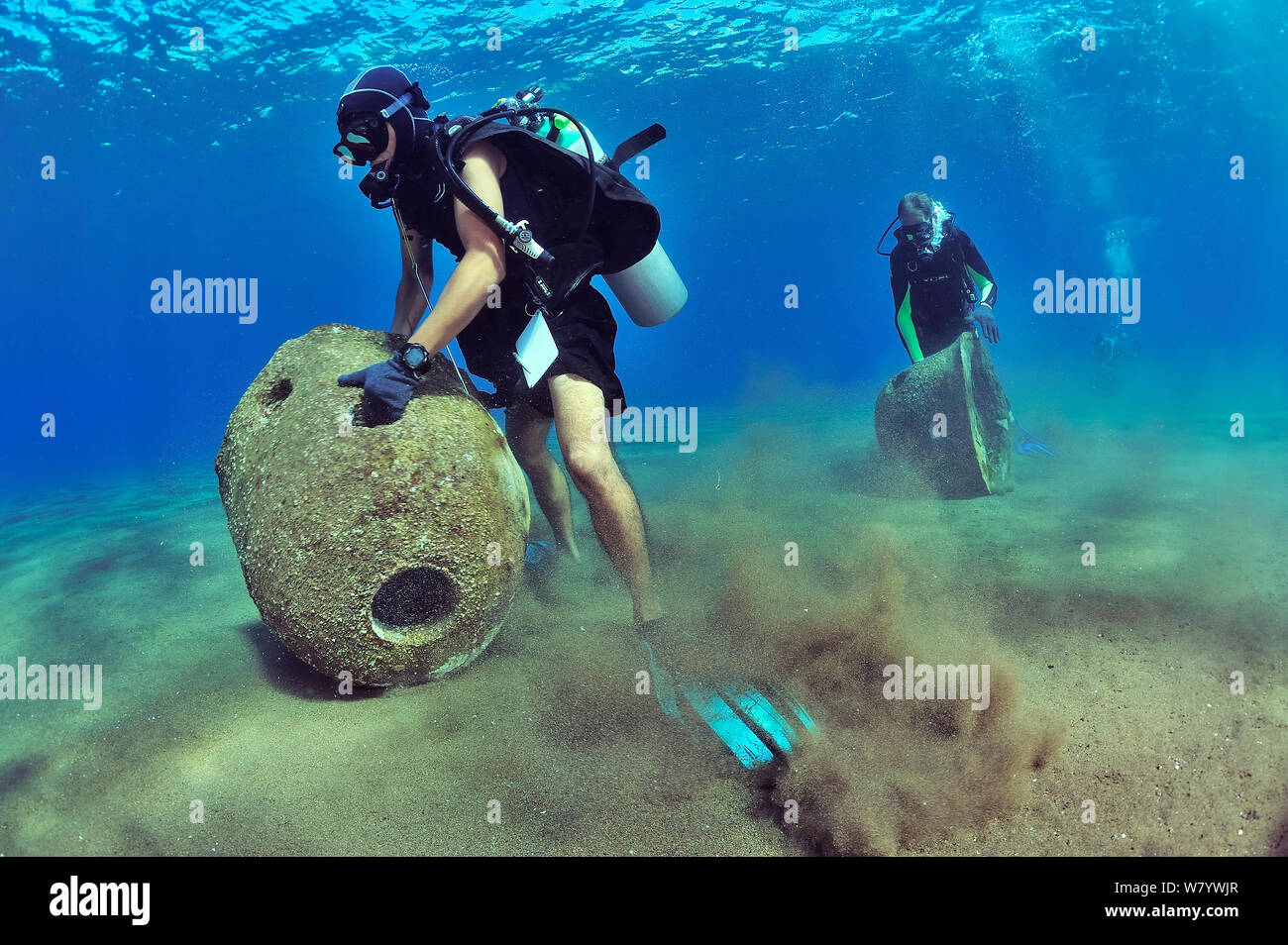 Divers are setting up concrete reef balls to build an artificial reef