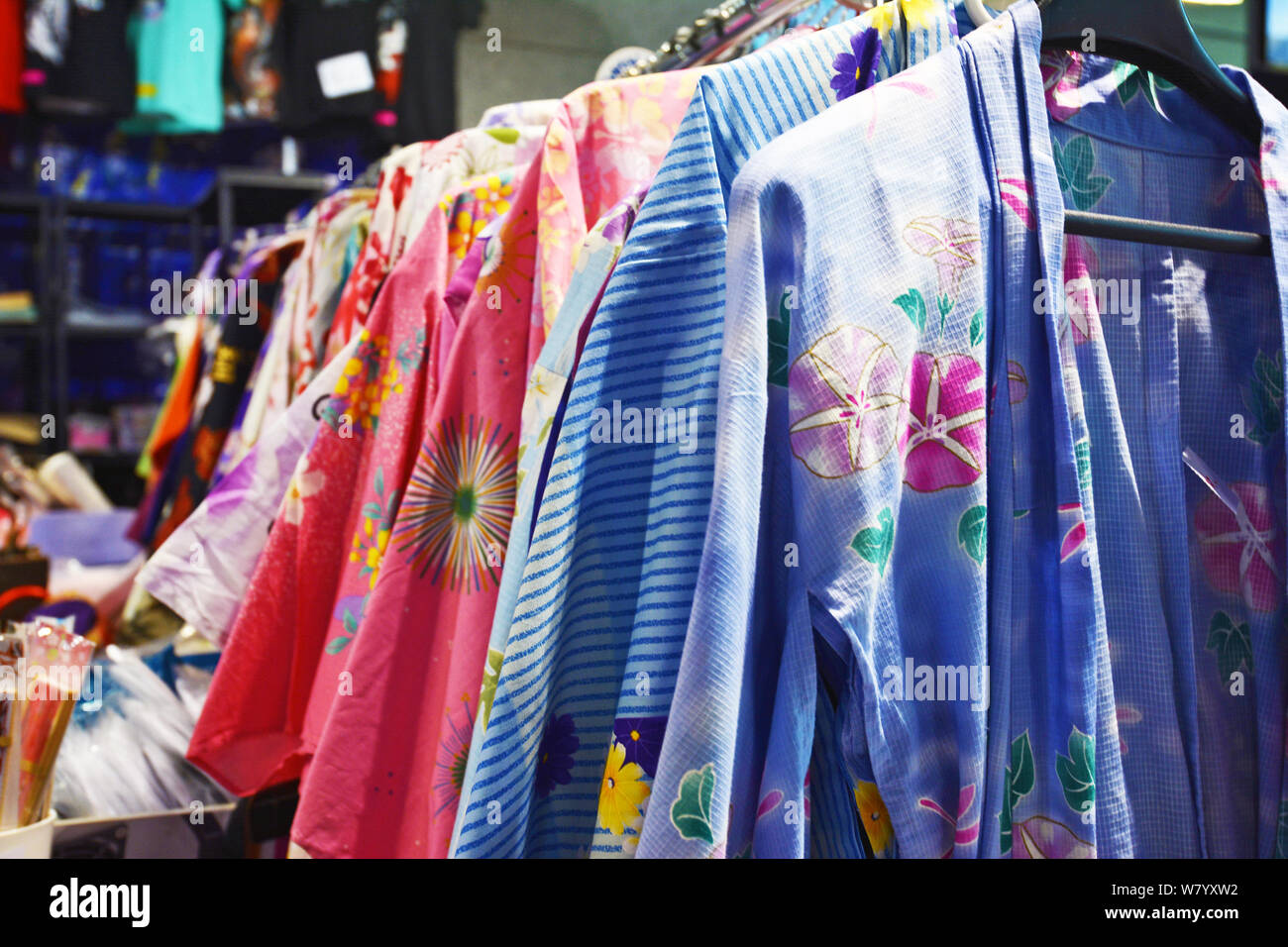 Traditional Japanese female summer garments called 'Yukata' with floral patterns on a rack Stock Photo