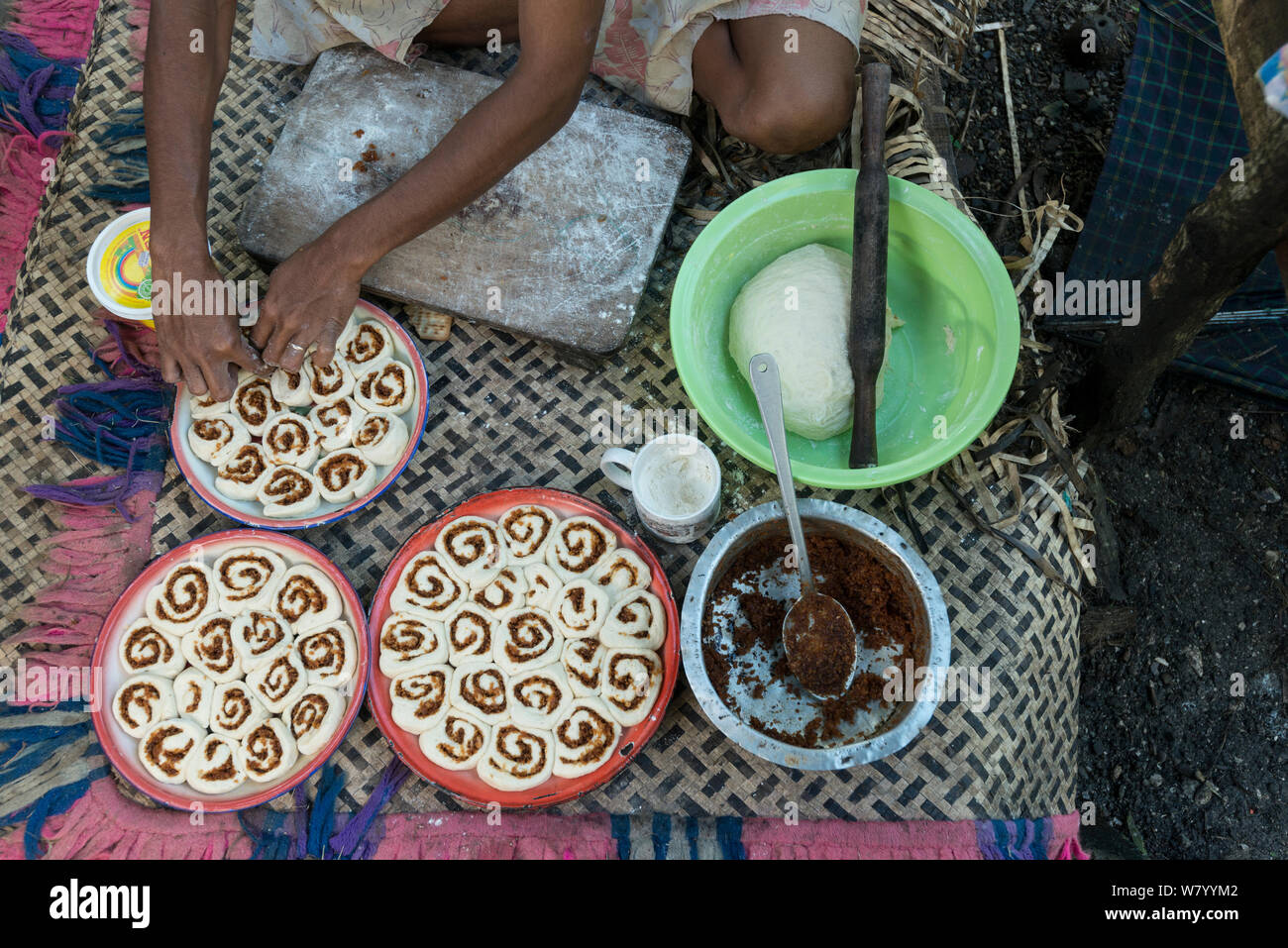 Man from Ligau Levu Village preparing roly poly bread with sweetend grated coconut for breakfast, Mali Island, Macuata Province, Fiji, South Pacific. August 2013 Stock Photo