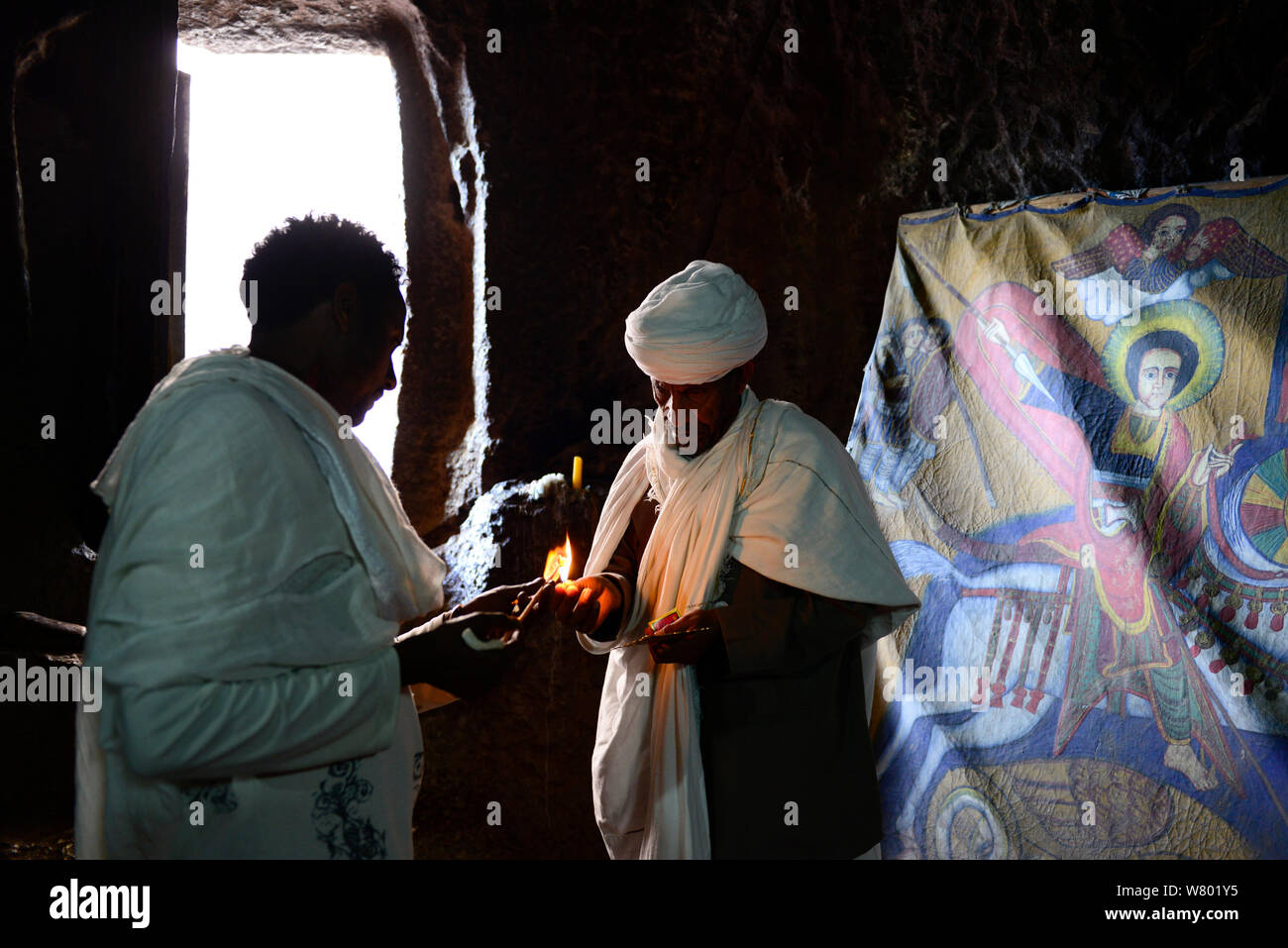 Priest in Bet Danaghel Church holding the Cross of King Lalibela. The  rock-hewn churches of Lalibela make it one of the greatest  Religio-Historical sites not only in Africa but in the Christian