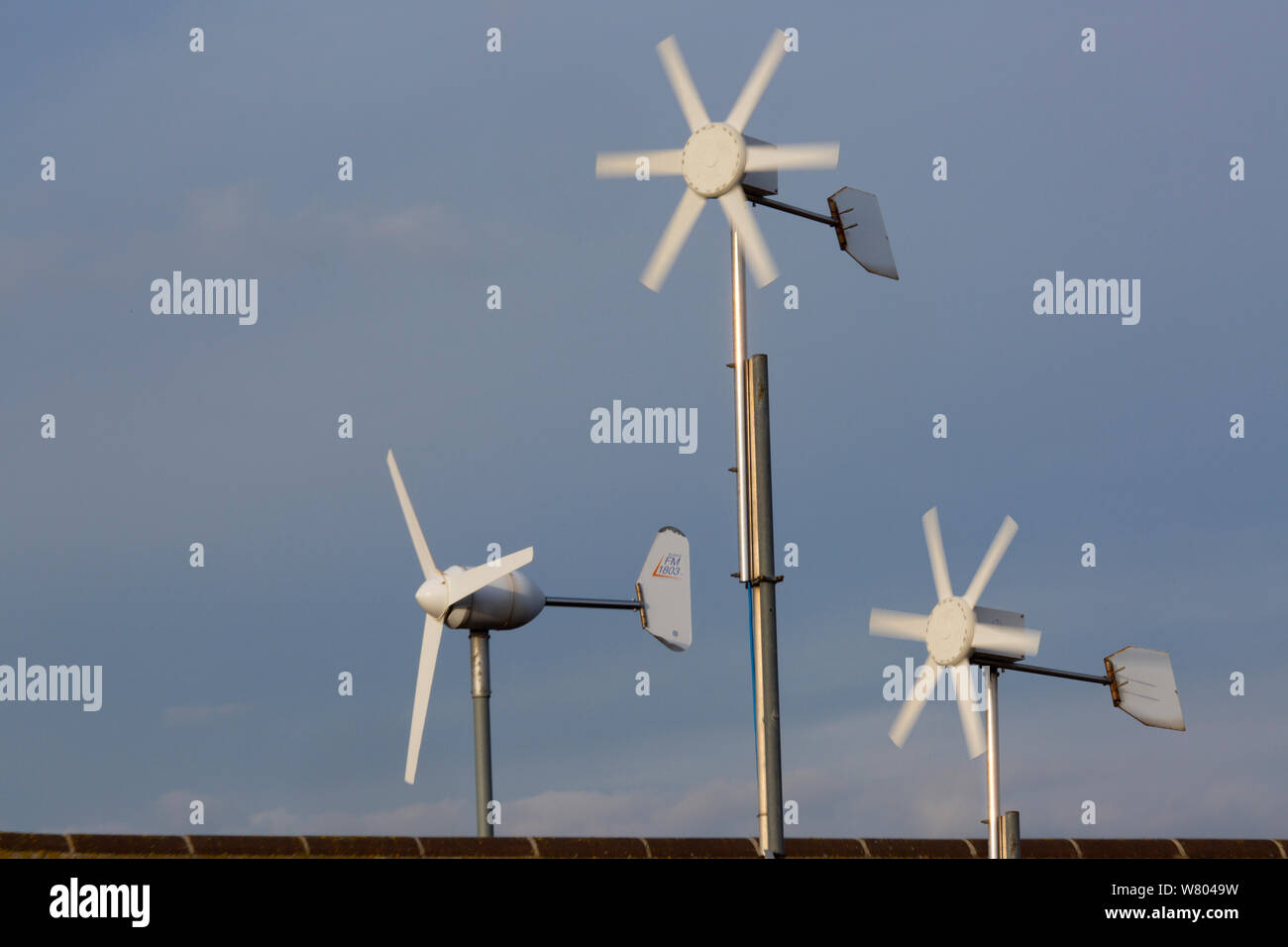 Domestic wind turbines on houses without mains electricity, The Wash, Snettisham, Norfolk, England, UK, February 2015. Stock Photo