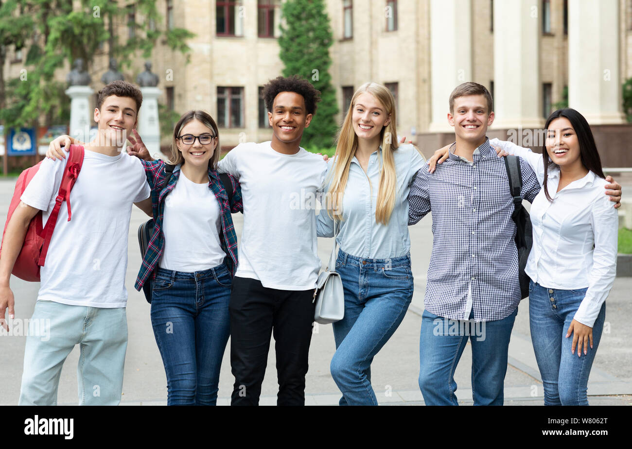 Group of students standing in front of university Stock Photo