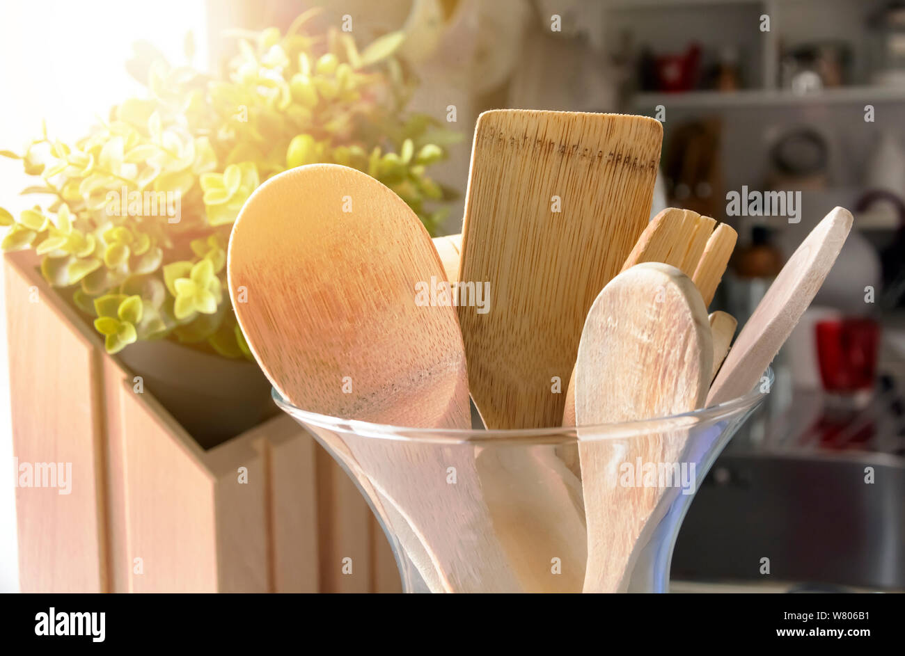 Closeup view of a group of wooden kitchen utensils inside a glass