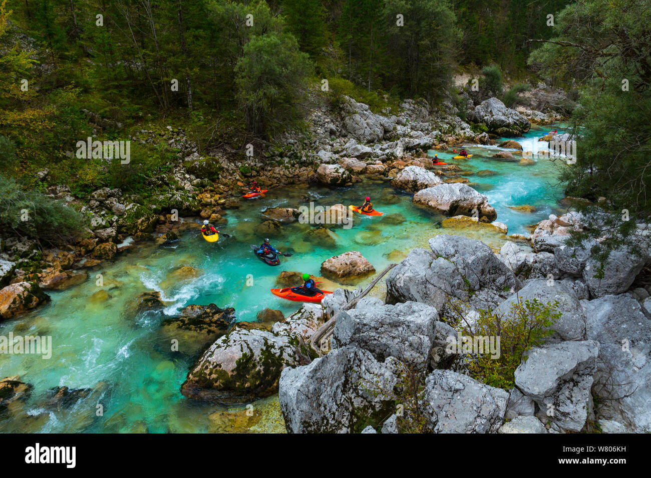 Group of kayakers in the Soca river, Julian Alps, Bovec, Slovenia, October 2014. Stock Photo