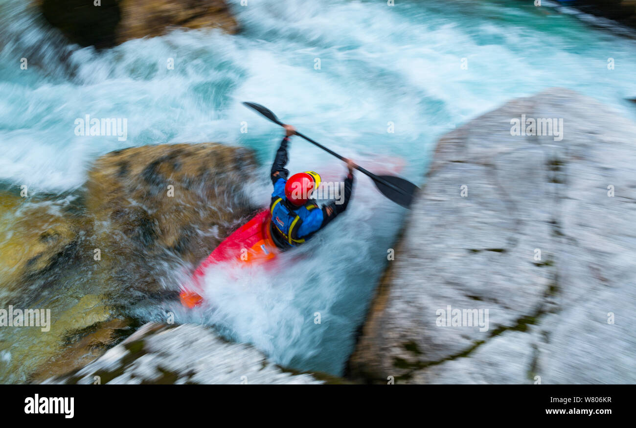 Kayaker going through rapids, Soca river, Julian Alps, Bovec, Slovenia, October 2014. Stock Photo