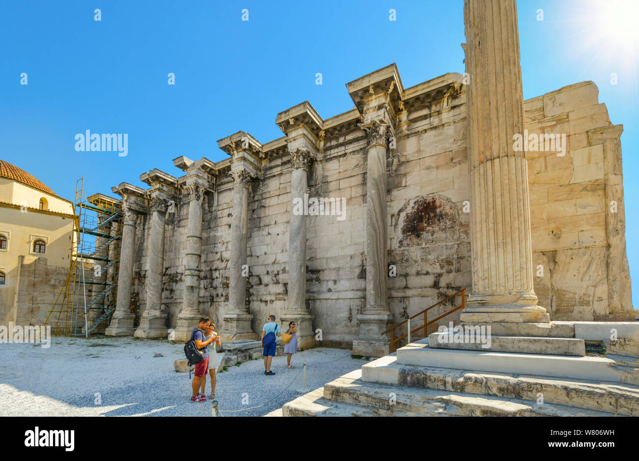 Ancient west wall of Hadrian's Library in the Roman Agora of Athens Greece  with tourists enjoying the greek ruins on a sunny, hot summer day Stock  Photo - Alamy