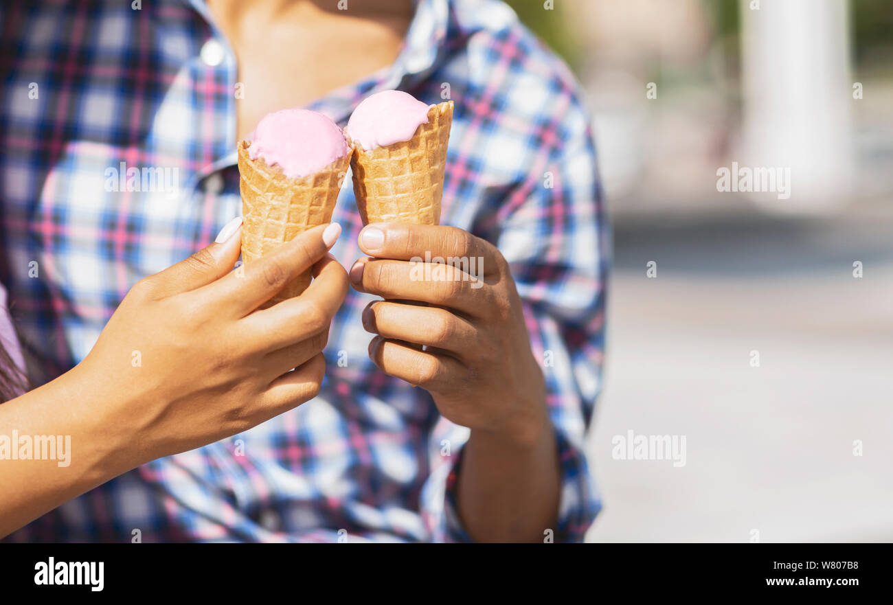 Young couple eating ice cream cones together Stock Photo