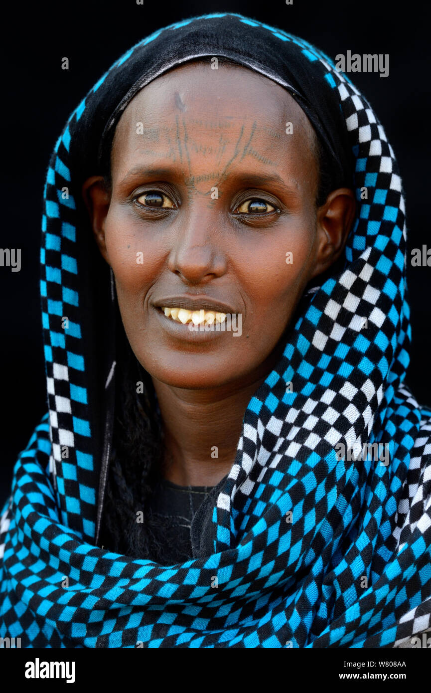 Head portrait of Afar tribe woman with facial tattoo /  skin scarifications and wearing head scarf, Malab-Dei village, Danakil depression, Afar region, Ethiopia, March 2015. Stock Photo