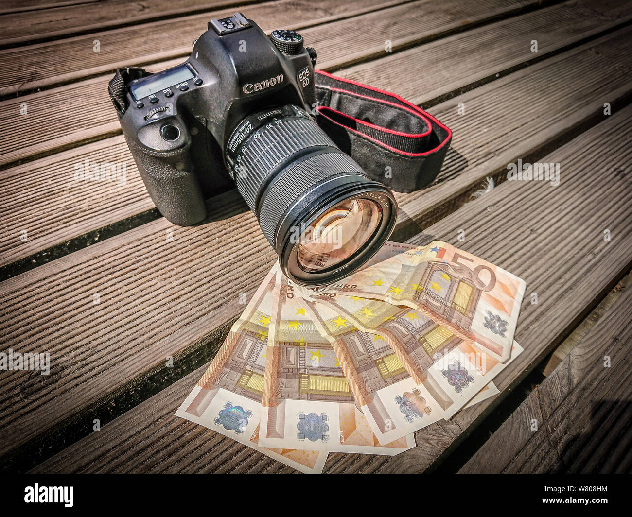 Camera on top of pile of euro cash Stock Photo