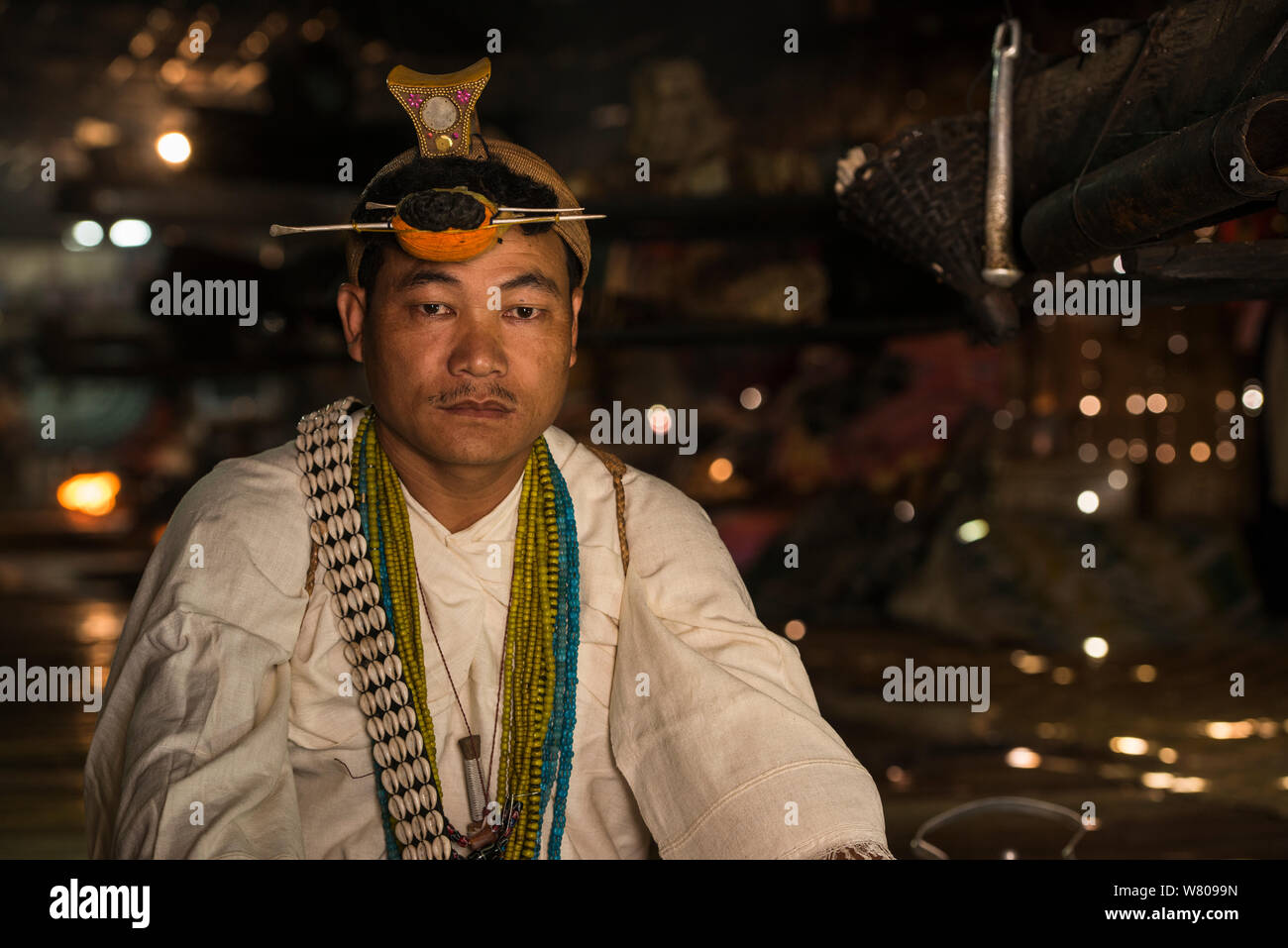 Nyshi man inside Nyshi Long House, Nyshi Tribe, Arunachal Pradesh.North East India, November 2014. Stock Photo