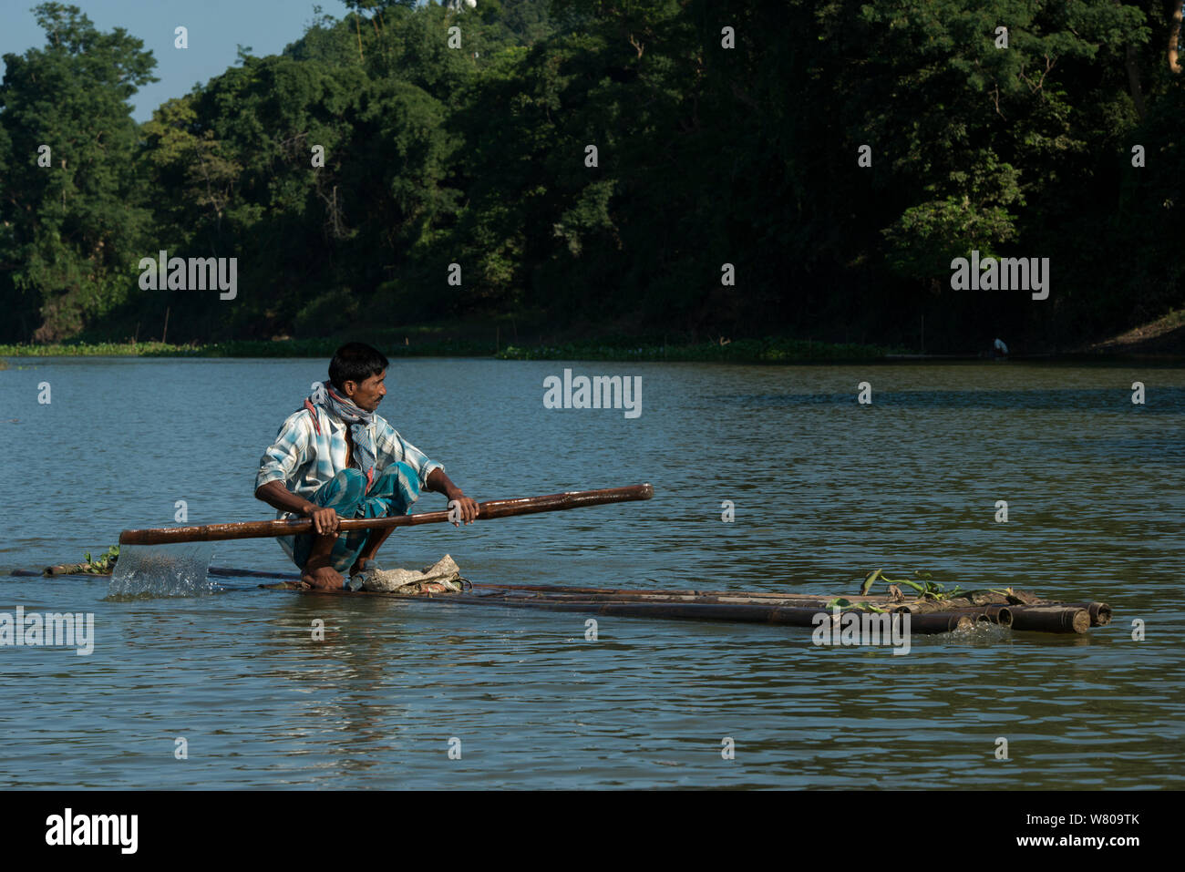 Fisherman on raft, Assam. North East India. October 2014. Stock Photo