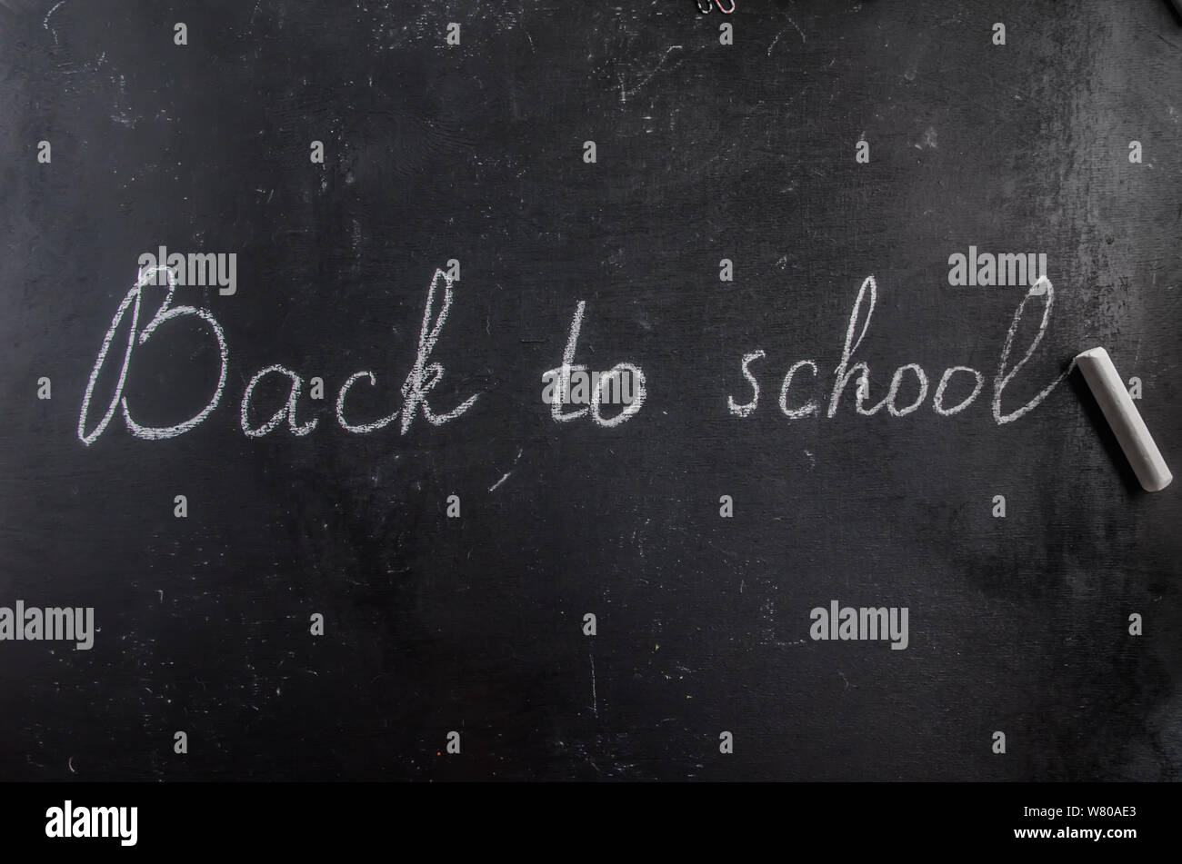 back to school written on a black chalk black board Stock Photo