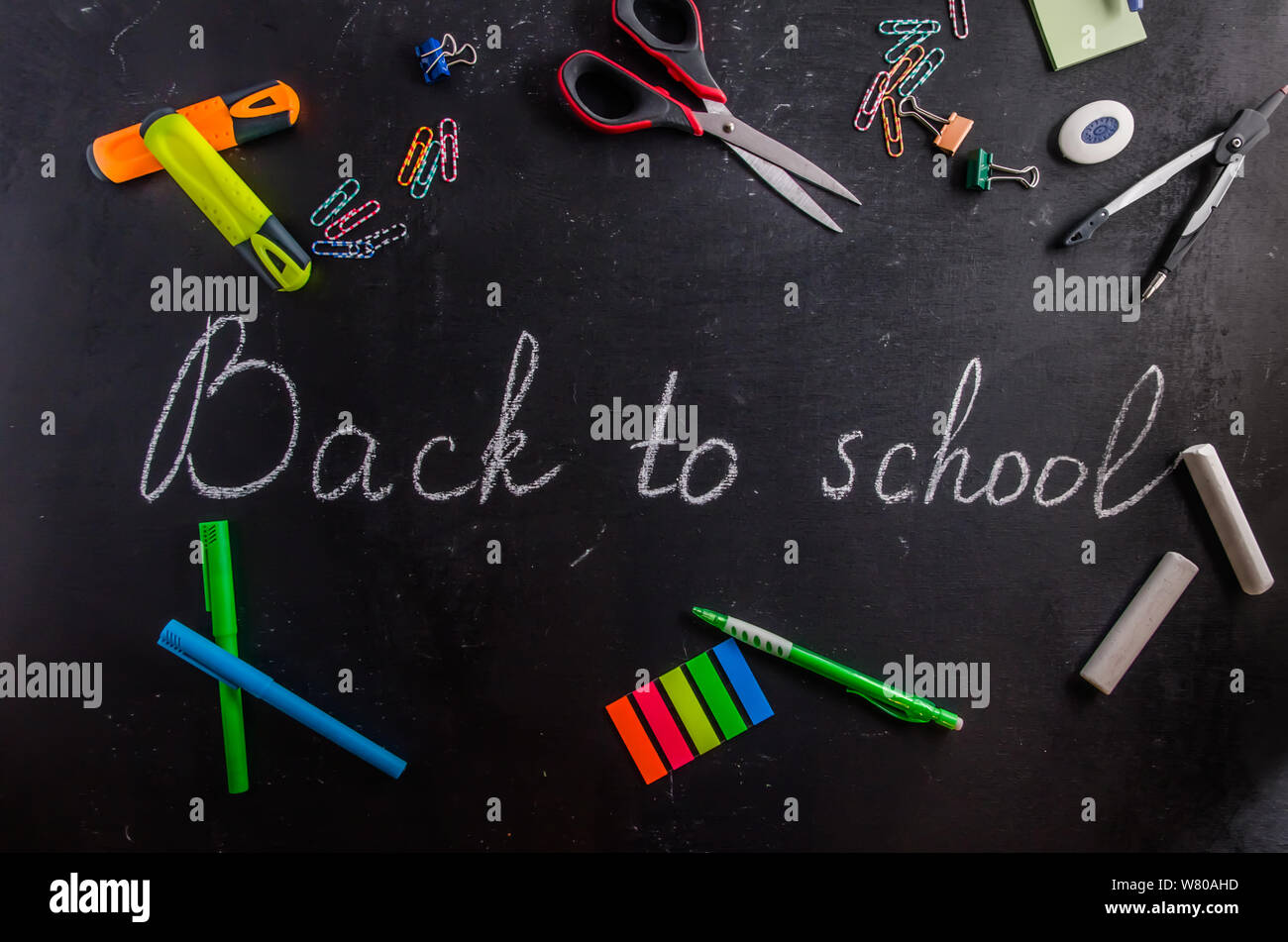 back to school written on a black chalk black board Stock Photo