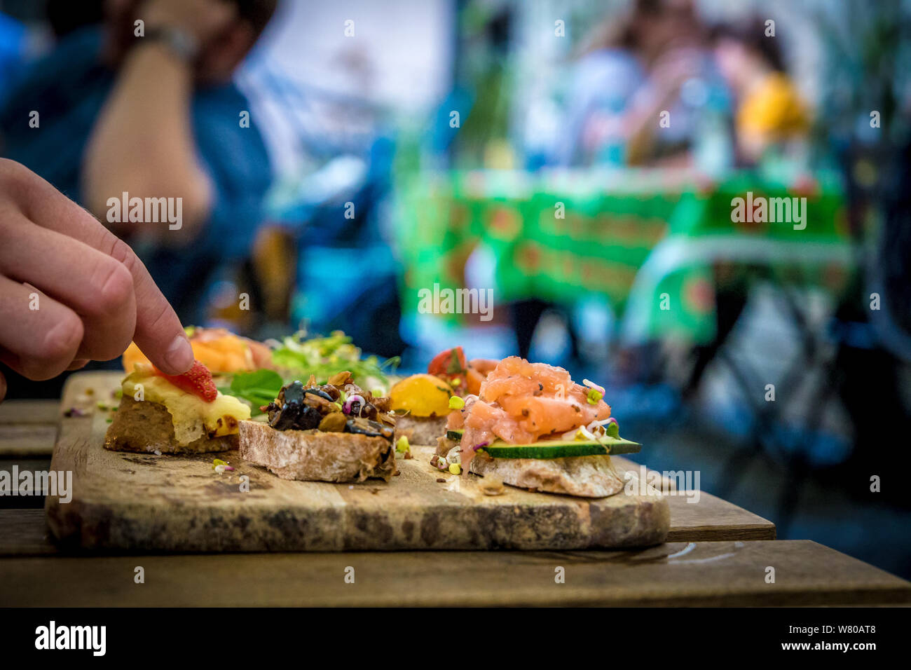 Bruschettas on wooden plate Stock Photo