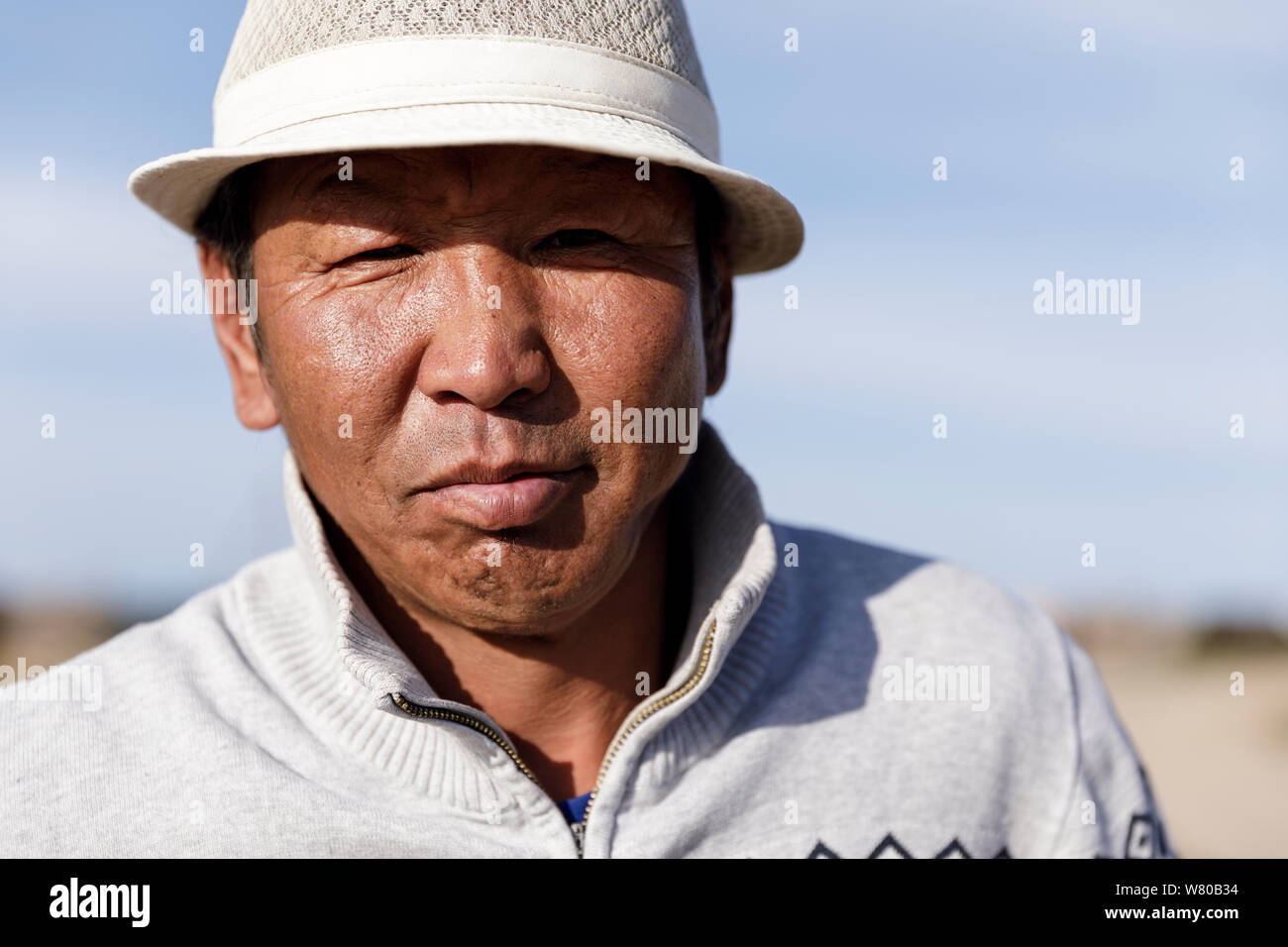 A Mongolian man poses for his portrait. Stock Photo