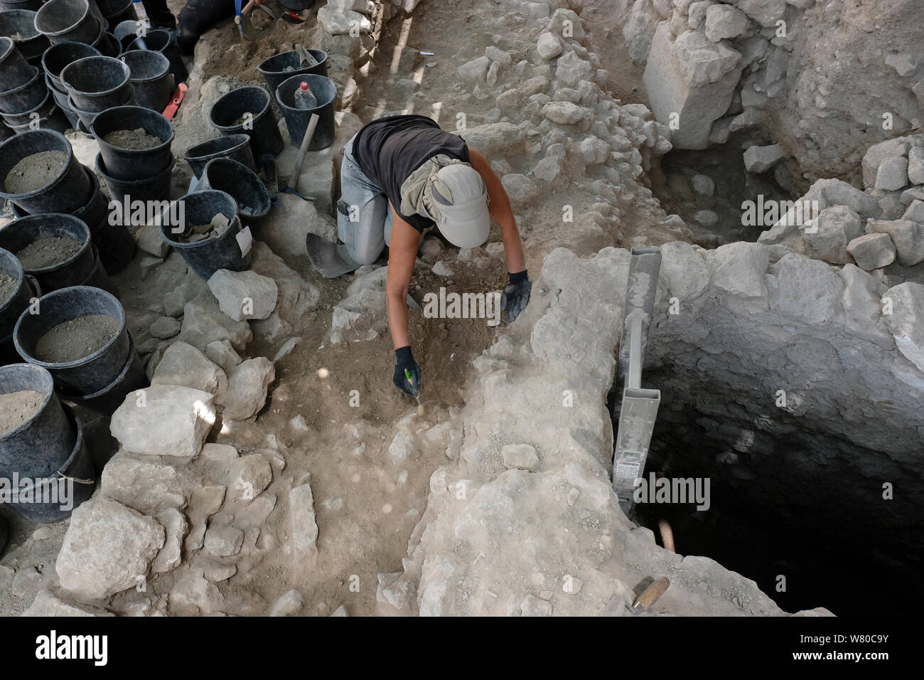 Worker of the Israel Antiquities Authority digging in ruins dating to the Ayyubid period in Ir David or City of David a major archaeological site near the Temple mount in East Jerusalem which is speculated to compose the original urban core of ancient Jerusalem dating to the First Temple period. Israel Stock Photo
