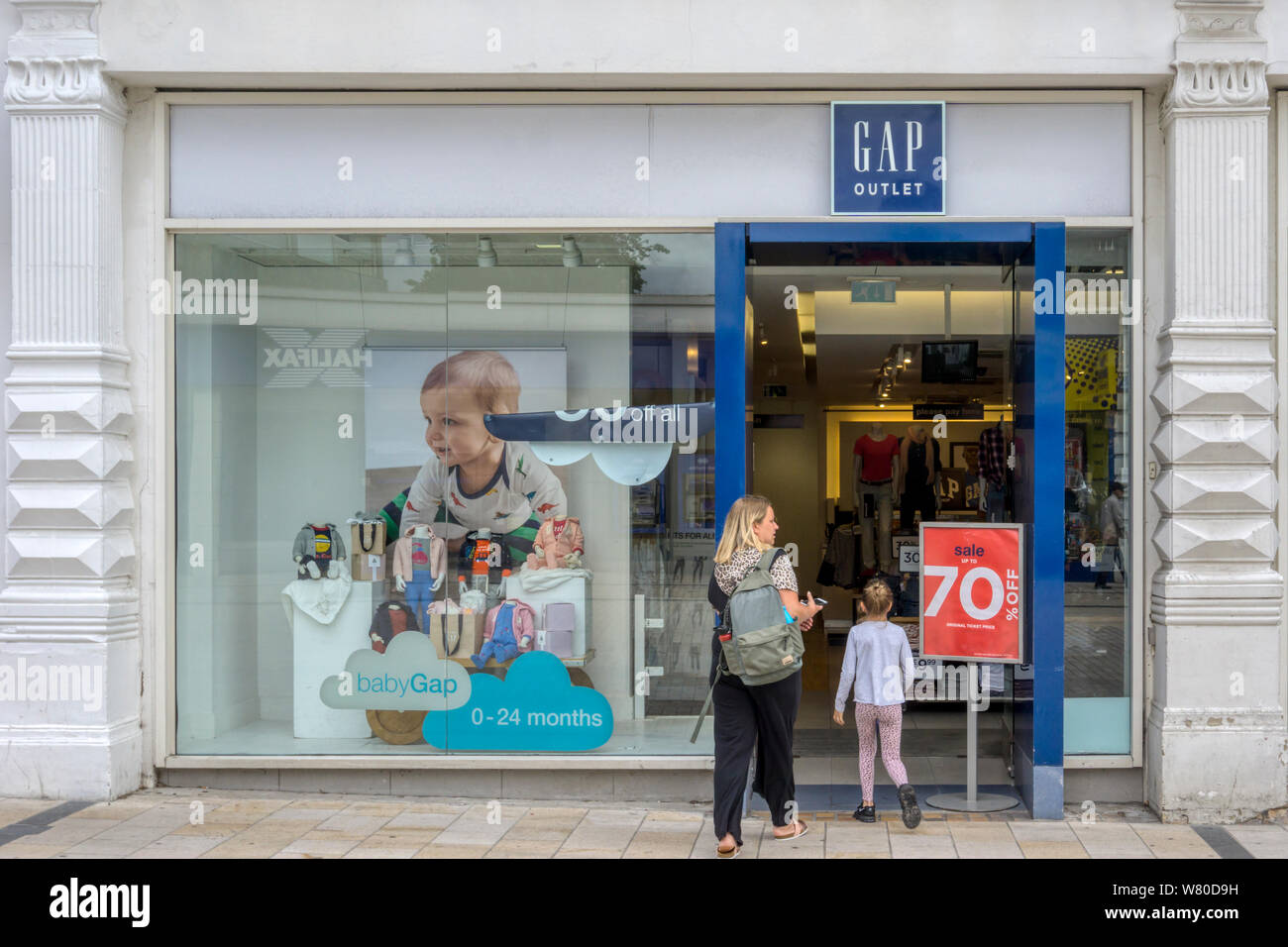 Possibly a mother & daughter visit a Gap outlet shop in Bromley High Street, South London. Stock Photo