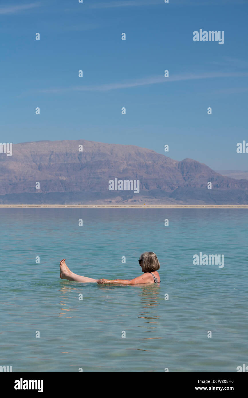Israel, Dead Sea. Female tourist floating and relaxing in the Dead Sea. Model released. Stock Photo