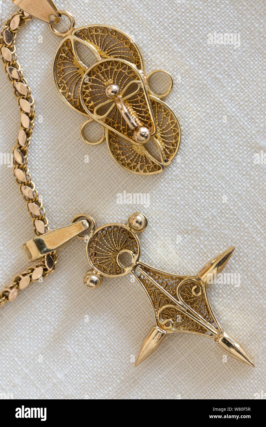 Close Up of African Pendants on a Gold Chain Stock Photo