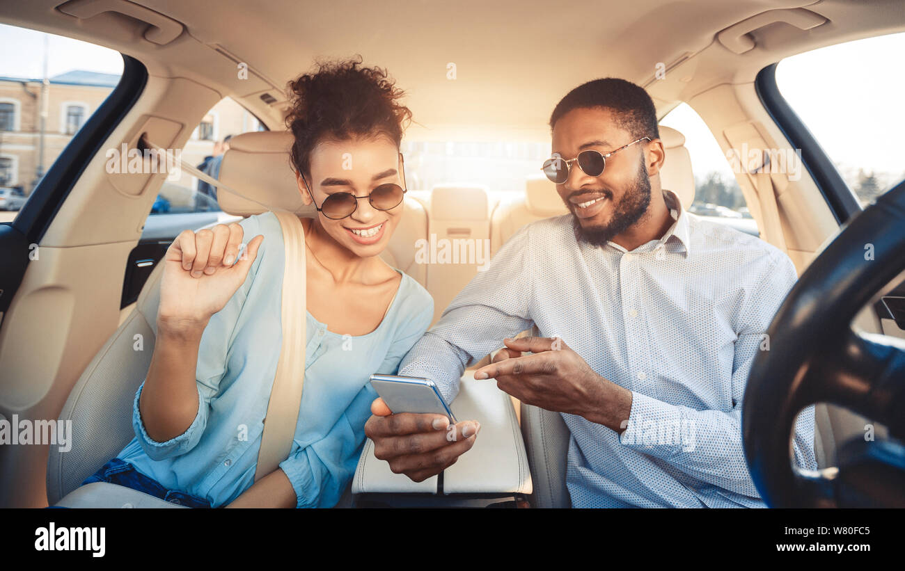 Young couple driving car and using digital map Stock Photo
