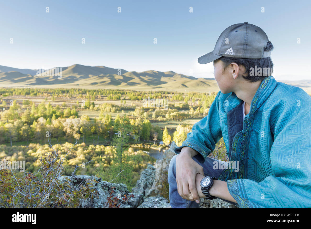 A young Mongolian man looks at the beautiful Gorkhi Terelj national park in Mongolia. Stock Photo