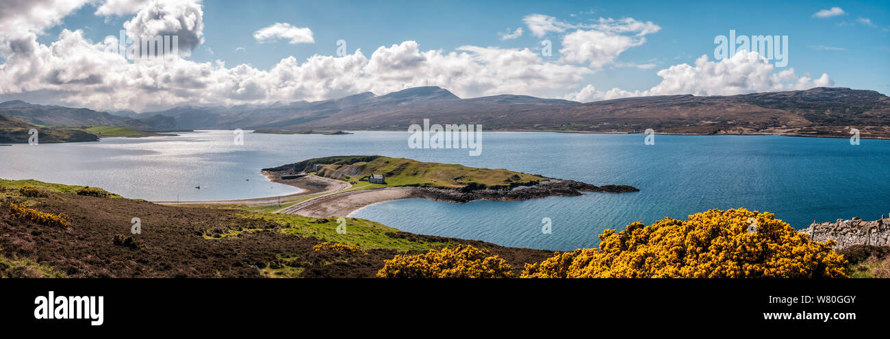 Panoramic view of the lime kilns and buildings on Ard Neakie, a rocky promontory on Loch Eriboll in Caithness in Scotland with snow capped mountains i Stock Photo