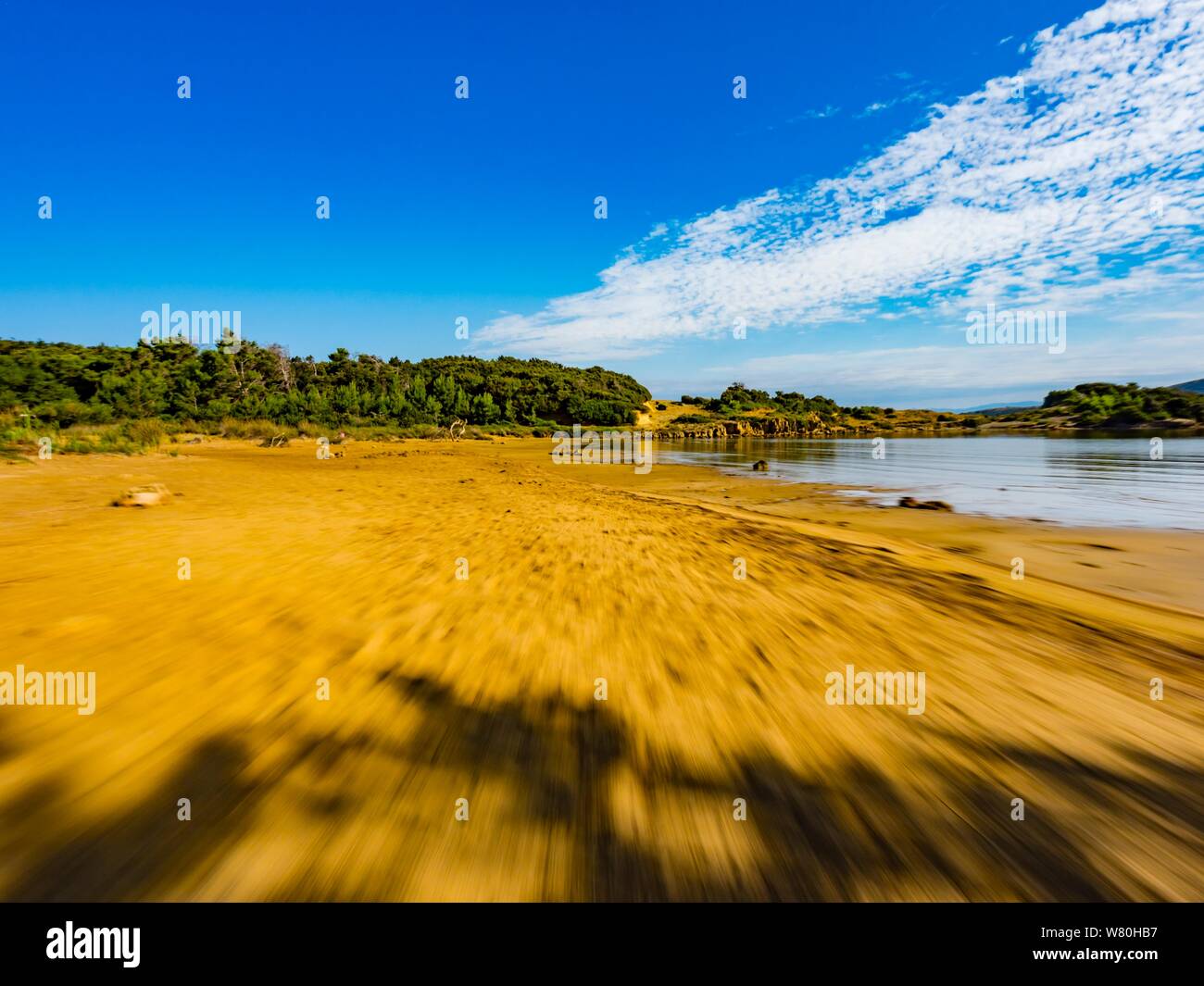 Sandy beach vacated vacant countryside speeding low view along Stock Photo