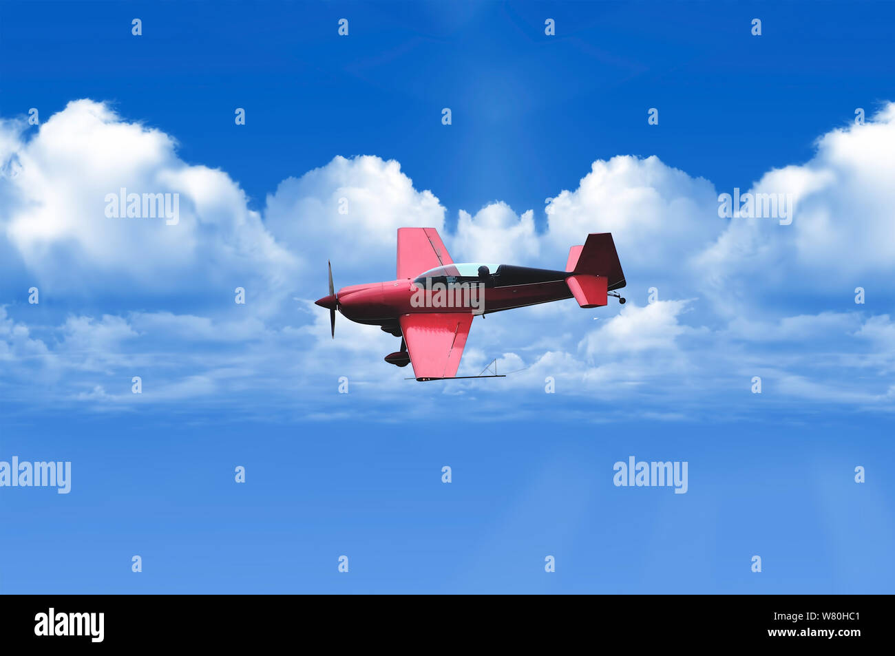 Biplane in blue Sky over clouds Stock Photo - Alamy