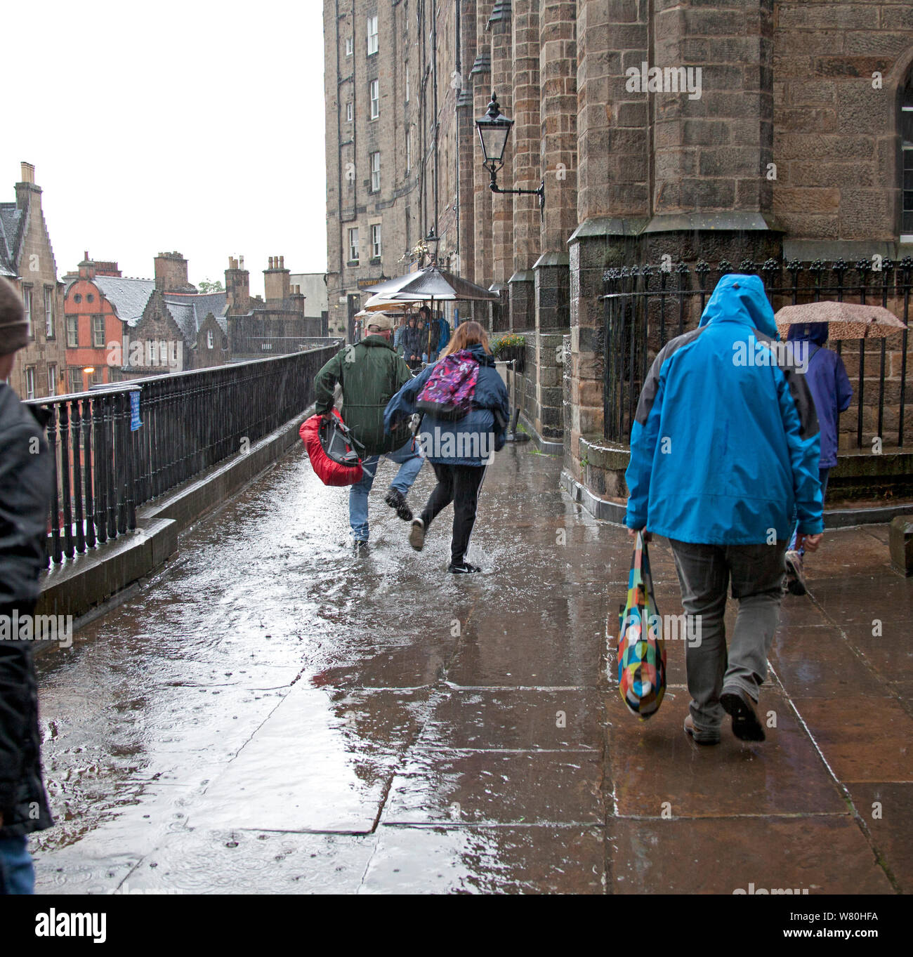 Edinburgh, Scotland, UK. 7th August 2019.Torrential downpours hit the city with thunder and lightning in late afternoon, causing most to run for cover under their umbrellas, slight flooding occurred in the city centre, above Victoria Street. Stock Photo