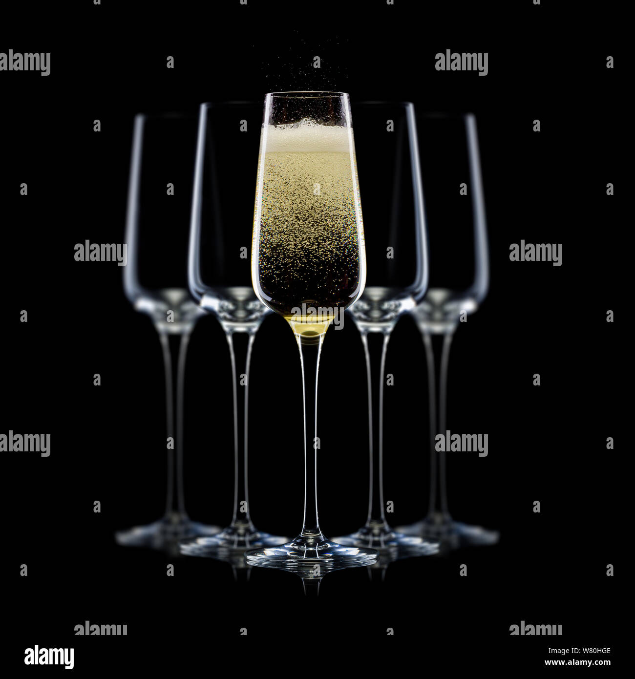 Set of luxury champagne glasses in a row isolated on a black background