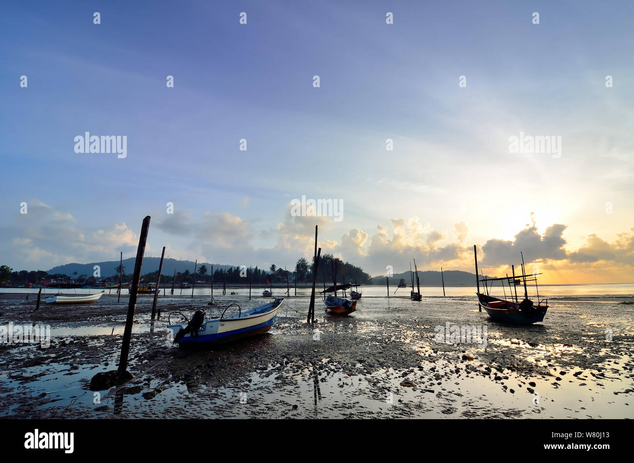 Fishing boat on the beach when sun rising up Stock Photo - Alamy