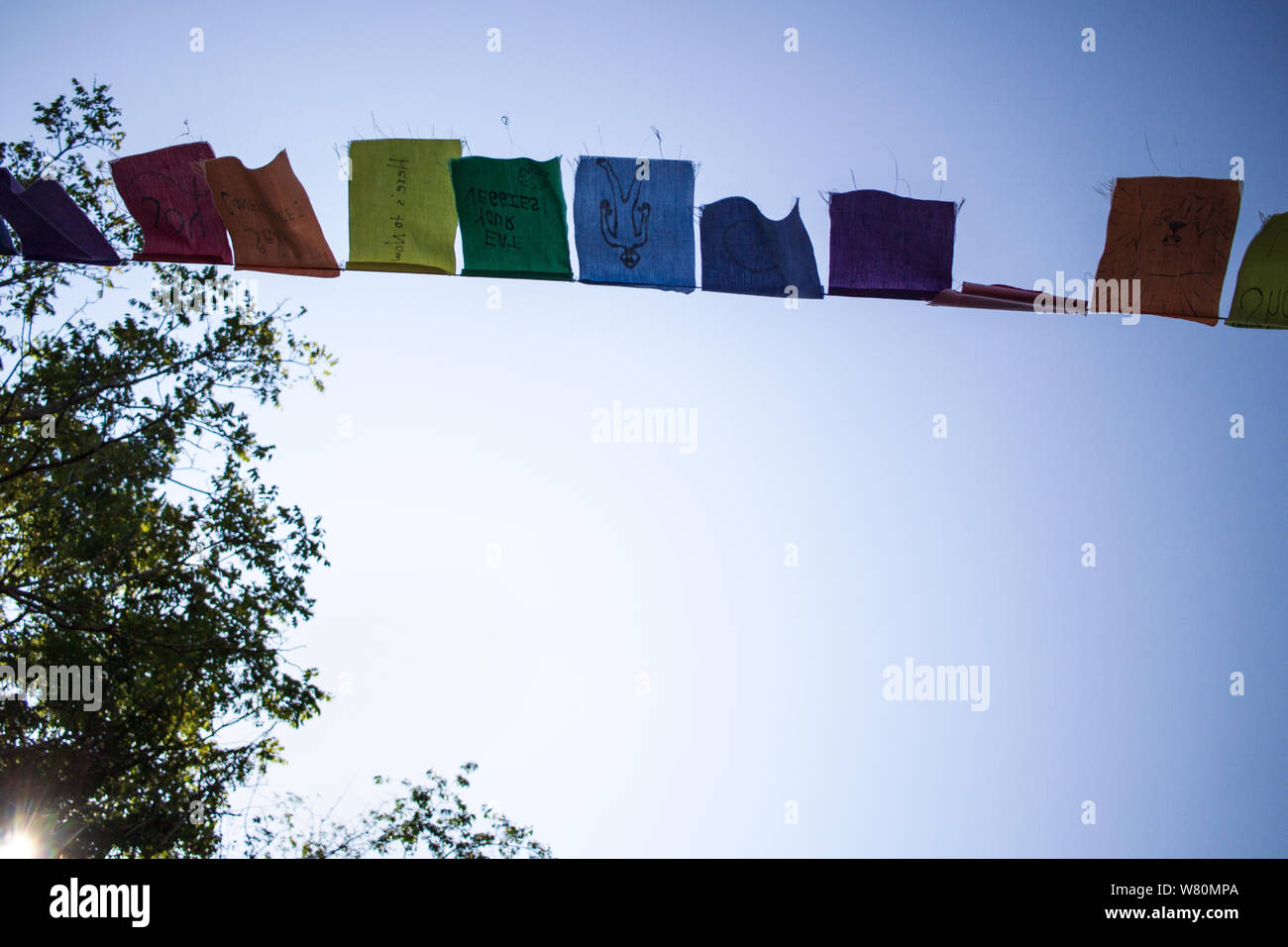 Prayer flags flap in the wind against a clear blue sky Stock Photo - Alamy