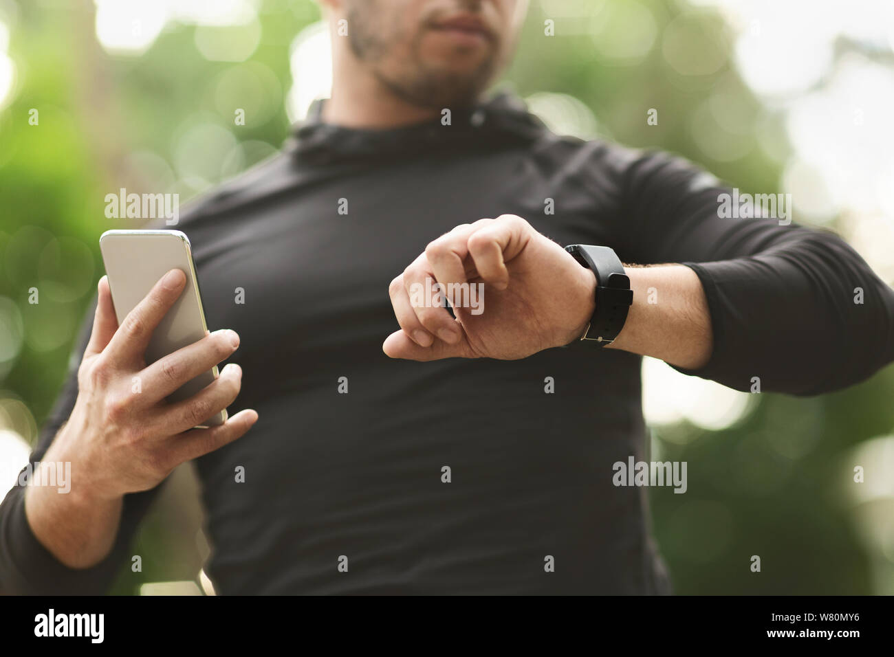 Male athlete using fitness app on his smartwatch Stock Photo