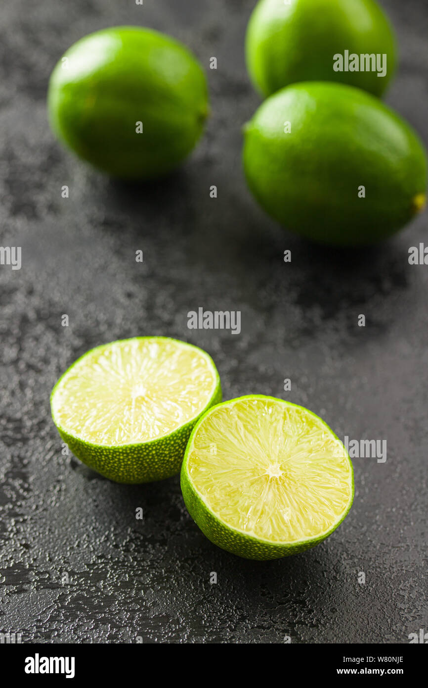 The green sliced lime on black table. Stock Photo