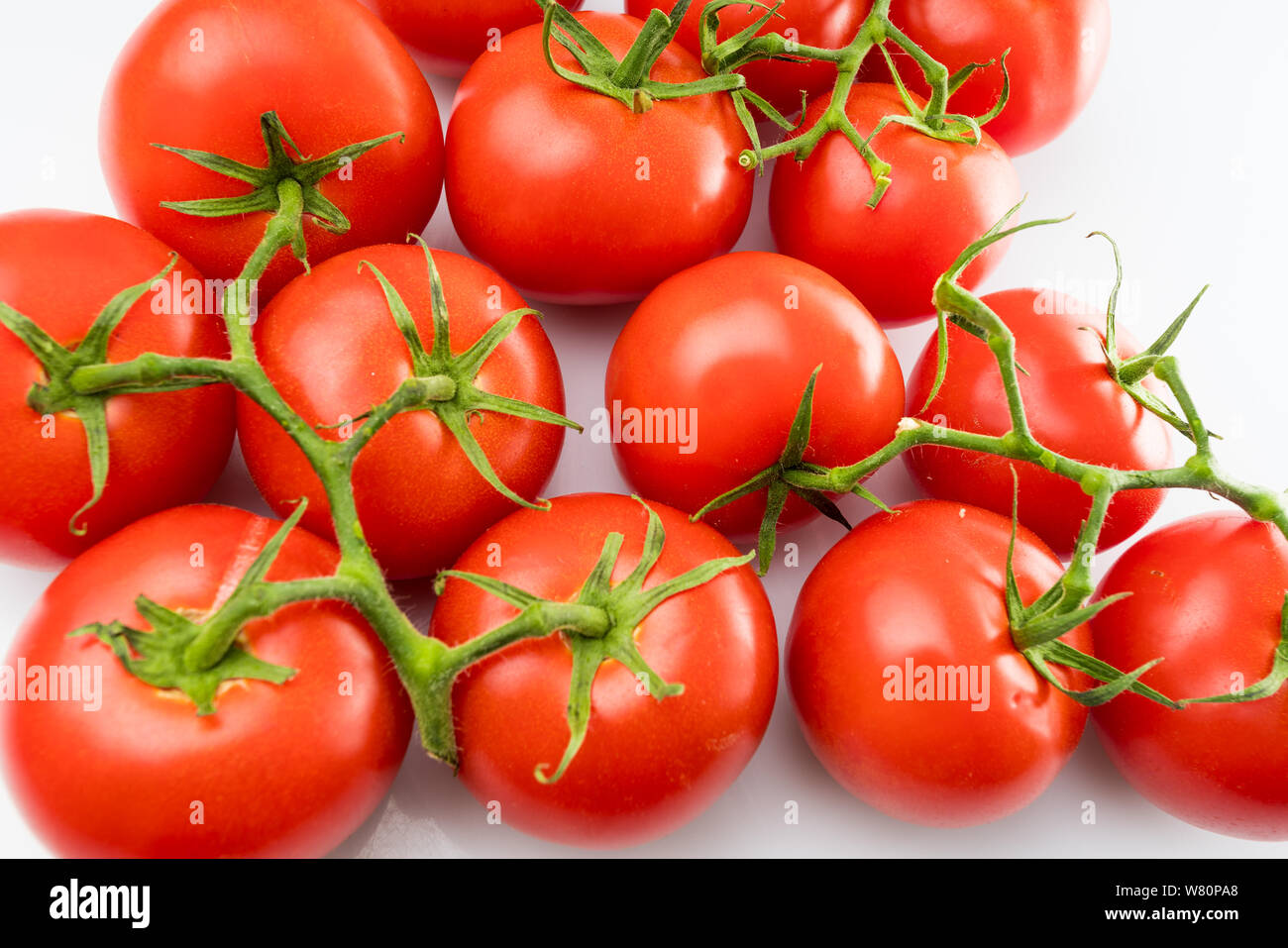 Tomato branch. Tomatoes isolated on white Stock Photo - Alamy
