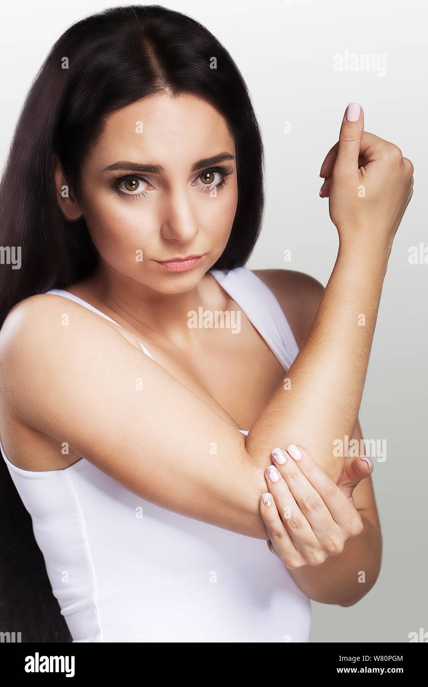 Pain in the elbow. The girl holds her hand for an elbow. Painful