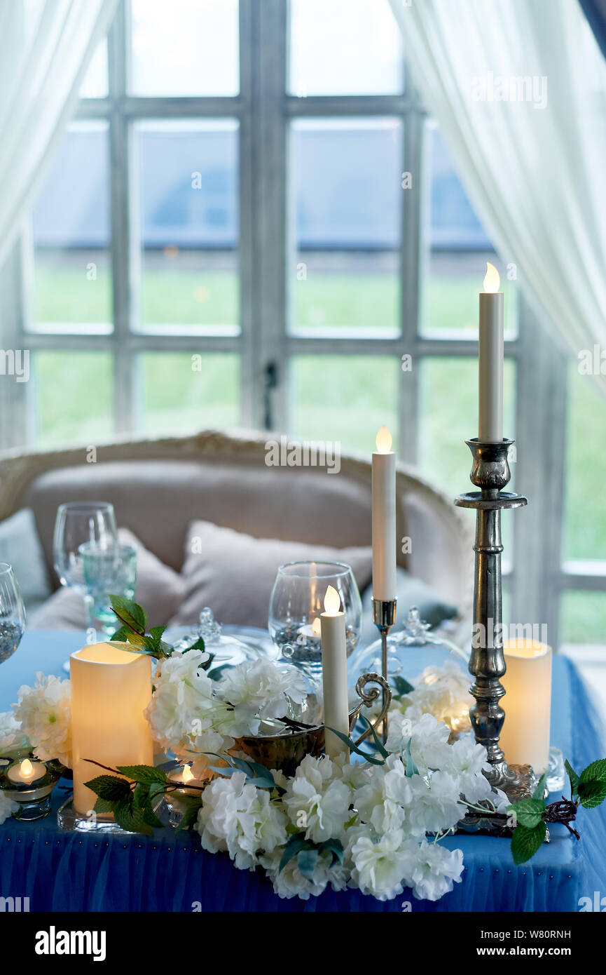 Wedding table decorated with white flowers, candles.. Blue and white ...