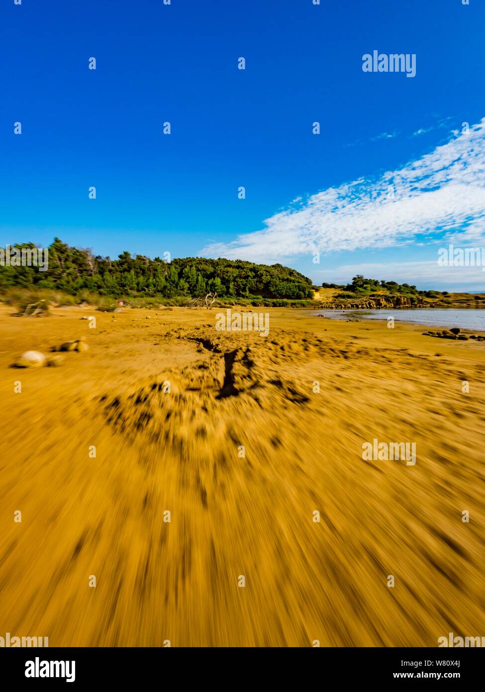 Sandy beach vacated vacant countryside speeding low view along Stock Photo