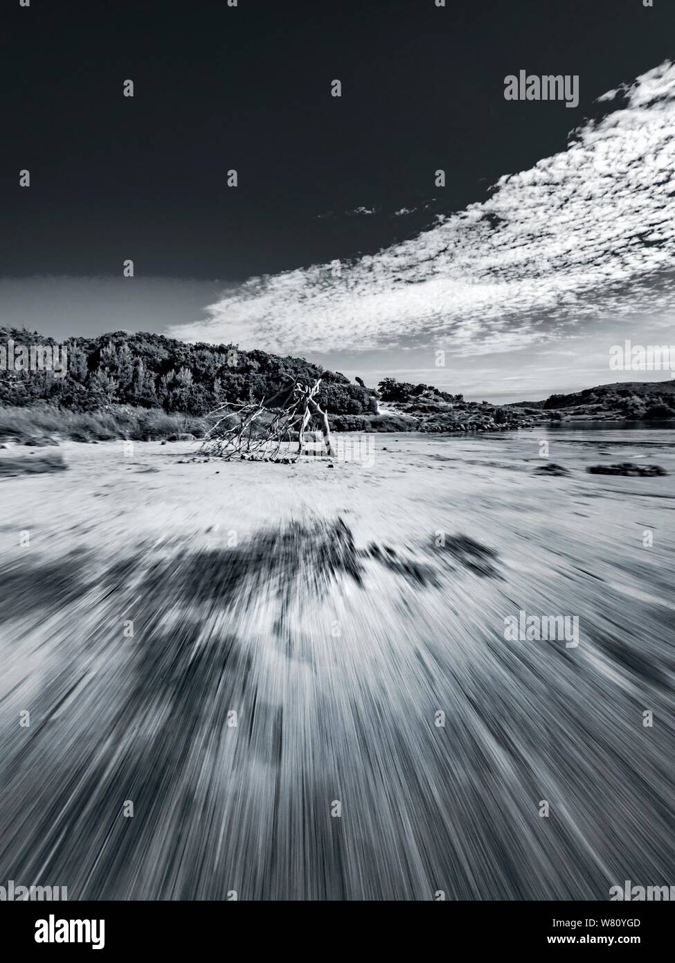 Sandy beach vacated vacant countryside speeding low view along Black and White B&W monochrome retro Stock Photo