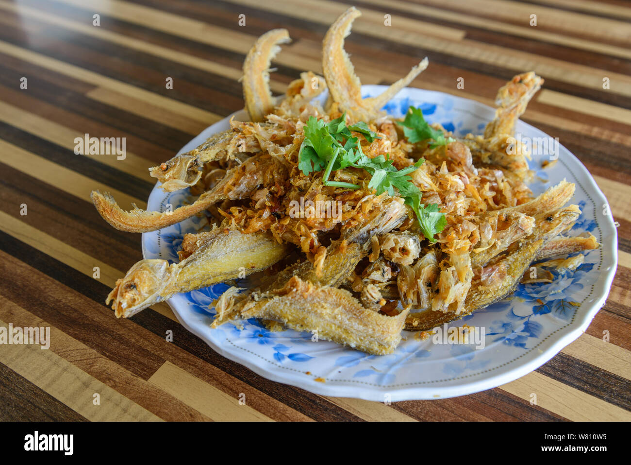 Fried crispy garlic soft fish or sheat fish, famous Thai meal menu for lunch or dinner. Stock Photo