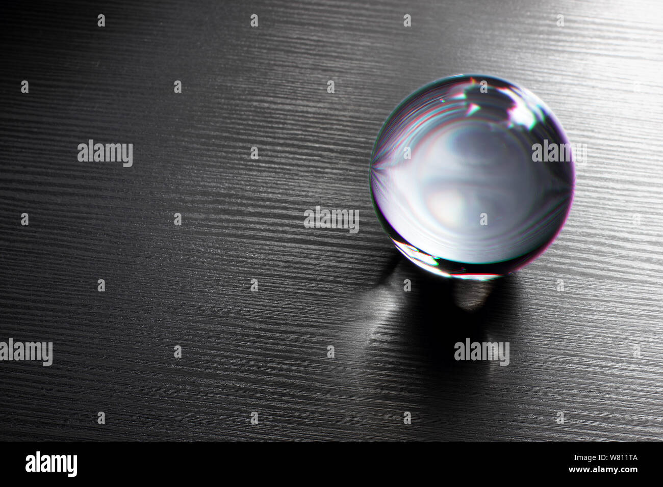 Glass Ball on Wooden Background Stock Photo