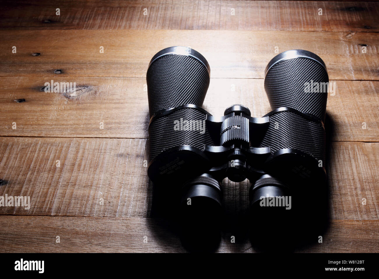 Binoculars on Rustic Wooden Background Stock Photo