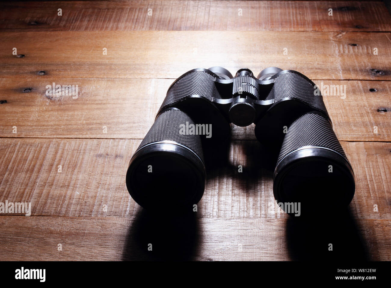 Binoculars on Rustic Wooden Background Stock Photo