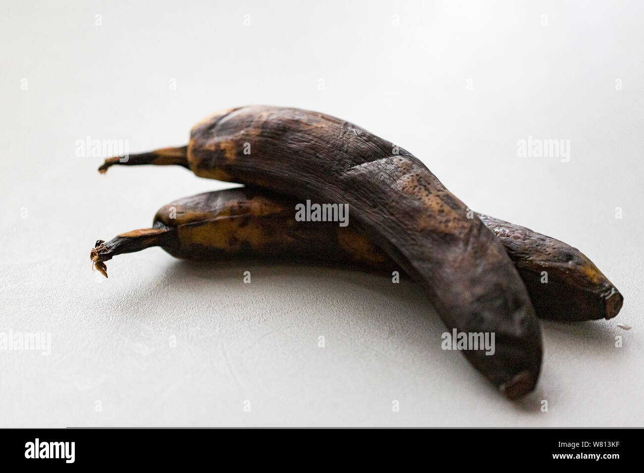 Dried unhealthy banana on white background. Trendy spoiled organic